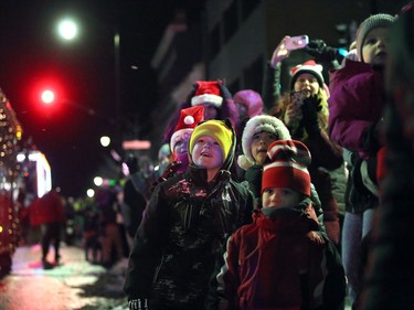 Kids watch Santa's sleigh pass by in downtown Kingston during the 2022 Nighttime Santa Parade on Saturday, Nov. 19, 2022. Meghan Balogh/The Kingston Whig-Standard/Postmedia Network