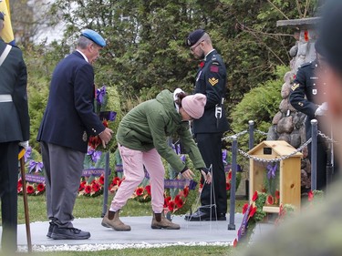 Tom Briggs, Royal Canadian Legion Branch 631 president, lays a wreath with a student from John XXIII Catholic school during the Matthew J Dawe Memorial Branch Remembrance Day cenotaph service in W. C Warnica Memorial Park in Kingston, Ont. on Friday, Nov. 11, 2022.