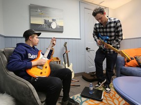 Adam Chadwick, left, plays guitar with rock band program mentor Ethan Stein at the Harmony Lounge and Music Club at St. Mary Magdalene Anglican Church in Napanee on Tuesday, Nov. 8. The free music program and after-school drop-in for teens runs Tuesdays and Thursdays.