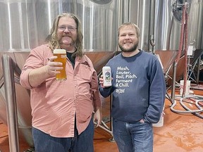 Beer aficionado Jordan St. John and Spearhead Brewing Company's Jacob Schmidt celebrate the creation of Dragon Slayer ESB, of which partial sales will go toward supporting the lunch program at St. George's Cathedral.
