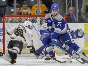 Kingston Frontenacs forward Christopher Thibodeau makes a diving swipe for the puck in front of Sudbury Wolves defenceman Nolan Collins in the first period of Ontario Hockey League action at the Leon's Centre on Friday.