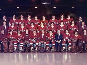 A team photo of the 1973-74 Kingston Canadians, the team's first season. The first coach, fourth from left, is Jack "Red" Bownass, beside first captain Gord Buynak, team president Jim Magee, assistant captain Mike O'Connell, and first general manager Walter "Punch" Scherer (blue suit).
