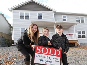Courtney Larocque, along with her sons, Ben, 6, and James, 8, will be moving into their Habitat for Humanity home on Rose Abbey Drive in Kingston on Friday.