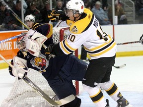 Nathan Moon of the Kingston Frontenacs knocks down Barrie Colts goaltender Peter DiSalvo in Ontario Hockey League action at the K-Rock Centre in Kingston on Friday, Nov. 5, 2010. Moon leads franchise players in career regular season games played, with 316, and is third in points with 332.