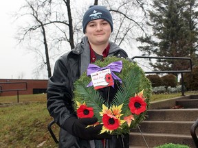 Jacob Ryan of the 288 Red Fox Royal Canadian Air Cadets holds a wreath that was placed at Kirkland Lake's cenotaph during the 2022 Remembrance Day ceremony. Photo - BRAD SHERRATT