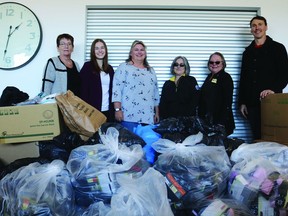 Dr. Bretton Baynes (right) of Baynes Family Wellness dropped off a record-setting haul of socks and underwear at the Leduc Hub Association, Nov. 18. The donations were collected through the sixth annual Toasty Toes and Underclothes program. (Peter Williams)