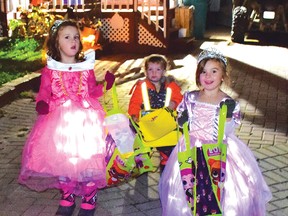 Photo by KEVIN McSHEFFREY
These two princesses, Kristen and Skylar Major, and a bulldozer, Braden Major, were dressed in colourful costumes and enjoying their quest for candy on Halloween night in Elliot Lake.