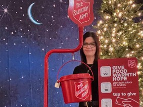 Owen Sound Salvation Army family services co-ordinator Alice Wannan, with a kettle equipped with the TipTap system that allows for debit, credit and cellphone pay options.