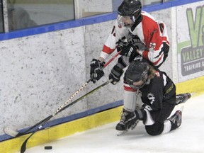 Players for the Deep River Knights (white) and the Muskrat Voyageurs (black) battle for the puck during action in the C division quarter-final round at the Pembroke Regional Silver Stick Tournament on Nov. 27. Anthony Dixon