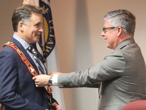 Town of Petawawa CAO Dan Scissons places the chain of office around the neck of new Mayor Gary Serviss during council's inaugural meeting. Anthony Dixon