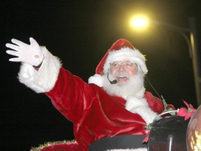 The hit of the parade, Santa Claus, waves to the crowds lining Pembroke Street during the annual Santa Claus Parade of Lights on Nov. 26. Anthony Dixon