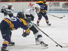 Woodstock's Riley Benko shields the puck from a New Hamburg player during the PJHL game Friday at Southwood Arena.