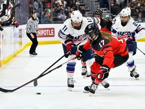 USA forward Abby Roque (11) and Canada defenceman Ella Shelton (17) fight for the puck during the third period at Climate Pledge Arena, Nov. 20. The U.S. defeated Canada 4-2.