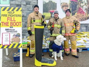 HOPING FOR A BOOTIFUL DAY Firefighters Sandy Bunting, Jeromy Van Hoek with his dog, Aspen and Jeff Lajoie who came out of retirement for the day take part in the fall Fill the Boot Drive for Muscular Dystrophy. Sault Ste. Marie Professional Firefighters Association set up donation sites across town at various retail outlets for their one-day fundraiser Thursday. BOB DAVIES