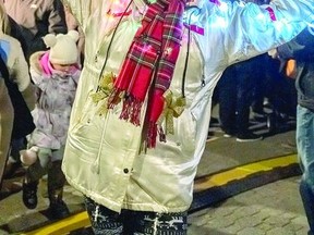 IN THE SPIRIT Sharon Vanderburg embraced the festive spirit with her coat covered with decorative lights at the downtown Treelighting Ceremony Thursday evening.  Approximately a thousand people attended the The Downtown Association's Moonlight Magic Treelighting evening with many staying to enjoy the late night shopping. BOB DAVIES