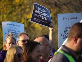 Members of the Canadian Union of Public Employees and supporters rally Tuesday evening outside the Point Edward office of Sarnia-Lambton MPP Bob Bailey.