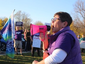 Michele LaLonge-Davey, president of Local 1238 of the Canadian Union of Public Employees, speaks to a rally Tuesday evening outside the Point Edward office of Sarnia-Lambton MPP Bob Bailey.