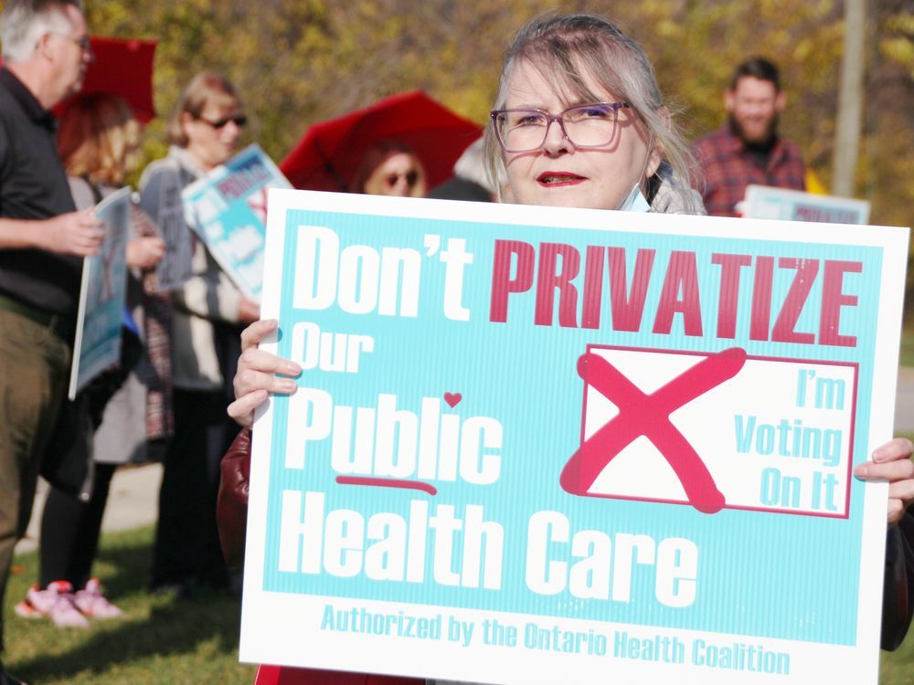 Shirley Roebuck with the Sarnia-Lambton Health Coalition organized a demonstration Thursday outside Sarnia-Lambton MPP Bob Bailey's office in Point Edward. (Tyler Kula/ The Observer)
