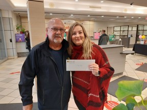 Teraze Gray, winner of the first early bird prize in the Noelle's Gift Vehicle and Cash Lottery, receives her prize in Sarnia from Roger Paquette of Noelle's Gift. A second early bird draw is this Friday and the final draw is Dec. 28.