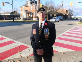Les Jones, president of Branch 62 of the Royal Canadian Legion, stands near the new crosswalk installed at the corner of Christina and Wellington streets in Sarnia to honour veterans.