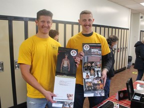 Sarnia firefighters Josh Loranger, left, and Joe McCormack hold copies of the Sarnia Firefighter's Calendar at a booth at the recent Big Brothers Big Sisters of Sarnia-Lambton sale.  The calendar is a fundraiser for the Sarnia Professional Firefighters Association community benefit fund which supports local charities and projects.