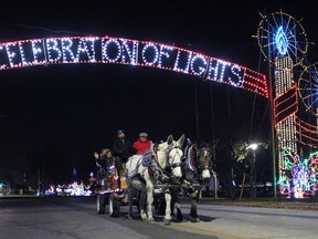 A horse-drawn wagon pulls a group of people under the Sarnia-Lambton's Celebration of Lights main display on Front Street North on Saturday night. Terry Bridge/Sarnia Observer/Postmedia Network