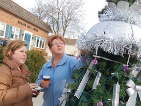 Pam Churchill, right, and Abbi Sexton are shown in this file photo checking out a Christmas tree decorated during a previous Christmas in the Village in Point Edward.