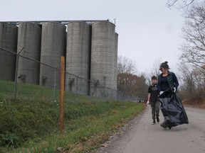 Amelie (right) and Remi Chanda pick up litter near 'the silos' on Nichol Street in Waterford Saturday during the Long Point Biosphere Region's second Cleaning Up Norfolk event.  CHRIS ABBOTT