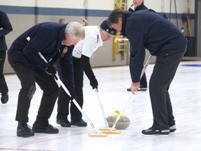 Scottish Rotarian skip Martin Forster (left) assists teammates Anne Forster and Graham Thom sweeping a rock Thursday, Nov. 10 at the Simcoe Curling Club during an international Canada-Scotland Rotary curling exchange.