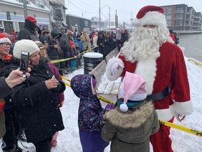 Santa Claus spent a few minutes speaking with children before he and Mrs.  Claus got on a horse-drawn sleigh to participate in Port Dover's Christmas Fest and Santa Claus Parade on Saturday, Nov. 17. VINCENT BALL