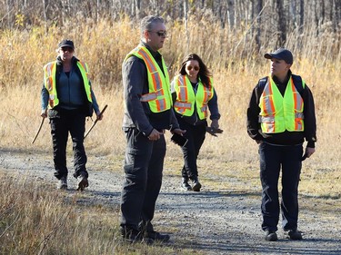 Brett Robinson, of Please Bring Me Home, takes part in a search at Rotary Park Trail in Sudbury, Ont. with local members Julie Charette, left, and Natashia Pickering, right, on Tuesday November 1, 2022. BlackTracks K9 was brought to Sudbury by the organization to take part in a search for Meagan Pilon, last seen on Sept. 11, 2013. John Lappa/Sudbury Star/Postmedia Network
