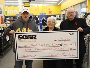 Kevin Conley, left, and Terry McKenzie, of the Steelworkers Organization of Active Retirees, present a $1,000 cheque to Mary Michasiw, chair of Keeping Seniors Warm, in Sudbury, Ont. on Wednesday November 2, 2022. The donation supports the organization. John Lappa/Sudbury Star/Postmedia Network