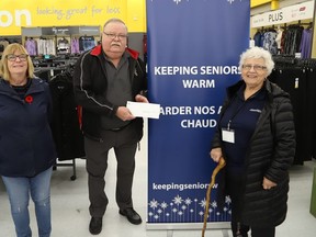 Ann Violette, left, and Blaine Lachance, of the Minnow Lake Lions Club, present a $500 cheque to Mary Michasiw, chair of Keeping Seniors Warm, in Sudbury, Ont. on Wednesday November 2, 2022. The donation supports the organization. John Lappa/Sudbury Star/Postmedia Network