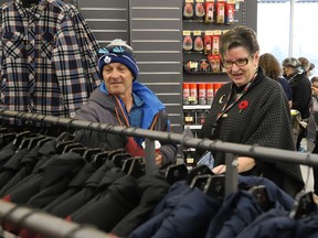 Volunteer Shirley Pella, of Branch 564 of the Royal Canadian Legion Ladies Auxiliary, helps James Plunkett search for a winter jacket at Giant Tiger in New Sudbury on Wednesday November 2, 2022. Keeping Seniors Warm held their fourth annual shopping event for 100 seniors who were given up to $175 each to shop with a volunteer. The seniors, who were referred to the organization by a number of different agencies, were also given a gift card, a handmade quilt, a bag of personal care items, and free transportation was provided by Greater Sudbury transit. Giant Tiger also provided support for the event. John Lappa/Sudbury Star/Postmedia Network
