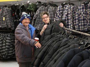 Volunteer Shirley Pella, of Branch 564 of the Royal Canadian Legion Ladies Auxiliary, helps James Plunkett search for a winter jacket at Giant Tiger in New Sudbury on Wednesday November 2, 2022. Keeping Seniors Warm held their fourth annual shopping event for 100 seniors who were given up to $175 each to shop with a volunteer. The seniors, who were referred to the organization by a number of different agencies, were also given a gift card, a handmade quilt, a bag of personal care items, and free transportation was provided by Greater Sudbury transit. Giant Tiger also provided support for the event. John Lappa/Sudbury Star/Postmedia Network