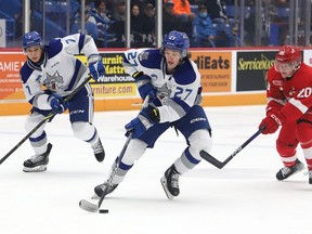 Quentin Musty, middle, of the Sudbury Wolves, skates past Connor Toms, of the Soo Greyhounds, during OHL action at the Sudbury Community Arena in Sudbury, Ont. on Wednesday November 2, 2022. John Lappa/Sudbury Star/Postmedia Network