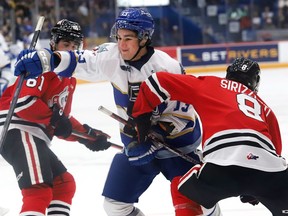 Kocha Delic, left, of the Sudbury Wolves, and Brenden Sirizzotti, of the Niagara IceDogs, battle for position during OHL action at the Sudbury Community Arena in Sudbury, Ont. on Friday November 4, 2022. John Lappa/Sudbury Star/Postmedia Network