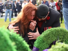 Silver Cross Mother Wendy Miller-Ealdama is comforted by veteran Randy Desarmeau at Branch 564 of the Royal Canadian Legion Remembrance Day Service at the Memorial Park Cenotaph in Sudbury, Ont. on Friday November 11, 2022. John Lappa/Sudbury Star/Postmedia Network