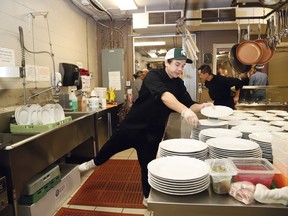 Chris Dickson, of Verdicchio Ristorante, gets plates ready for dinner being prepared by the restaurant for vulnerable citizens at the Elgin Street Mission in Sudbury, Ont. on Tuesday November 15, 2022. John Lappa/Sudbury Star/Postmedia Network