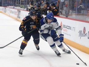 Jacob Holmes, right, of the Sudbury Wolves, attempts to skate around Declan McDonnell, of the Barrie Colts, during OHL action at the Sudbury Community Arena in Sudbury, Ont. on Friday November 18, 2022. John Lappa/Sudbury Star/Postmedia Network