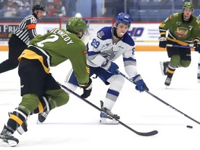 Nathan Villeneuve, right, of the Sudbury Wolves, attempts to skate around Wyatt Kennedy, of the North Bay Battalion, during OHL action at the Sudbury Community Arena in Sudbury, Ont. on Wednesday November 30, 2022. John Lappa/Sudbury Star/Postmedia Network
