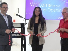 Timmins Mayor Kristin Murray cuts the ribbon to officially open NORCAT's new office located in the provincial government building in Porcupine. Assisting her are Jason Bubba, left, NORCAT's chief operating officer, and Ken Stewart, NORCAT's superintendent in charge of training and development in Timmins.

RON GRECH/The Daily Press