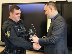 South Porcupine OPP Const. Graham MacGregor, left, is presented with the the Police Association of Ontario's Police "Hero of the Year" award from the association oresident Mark Baxter at a ceremony held at the South Porcupine detachment Tuesday morning.

ANDREW AUTIO/The Daily Press