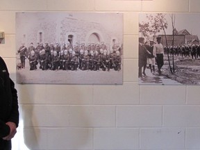 Former Hon. Lt. Col. Woody Linton (left) and current Honorary Lt. Col. Norbert Dufresne, discuss the two photo enlargements recently presented to the 116 Independent Field Battery and mounted on the wall in the unit’s All Ranks Mess. The photos depict the earliest two militia units in the community. Photo provided by Bob Stewart
