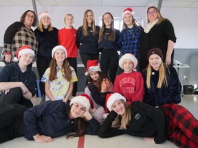 Volunteers at Children Shop for Christmas Saturday in Tillsonburg included from left (front) Thriver Company's Jordan Pottelberg, Kylee Carter, (middle row) Angelica Jamieson, Sophia Tomico, Evie Jamieson, Adelyn Hayes, Penelope Barr, (back) organizer Cathy Ryan, Thriver's Charlotte Barr, Cynthia Kirby, Renee Pelland, Elyse Pelland, Genevieve Jamieson, and volunteer Christina Gazley.  CHRIS ABBOTT