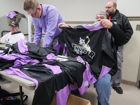 Tillsonburg Thunder GM Bill Ryan holds up one of the game-worn jerseys auctioned Saturday night for Hockey Fights Cancer.  The Thunder raised $4,867 through its silent auctions and Mike Findlay's haircut for Locks of Love.  CHRIS ABBOTT