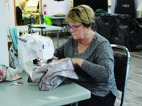 Susan McKay sews a cloth bag at the Vulcan Senior Centre on Saturday. A total of 10 volunteers took park in a sewing bee that afternoon to make bags that the Vulcan Municipal Library is selling to patrons as it transitions away from plastic bags. Library manager Connie Clement said the library is hoping patrons will reuse the cloth bags, with the library charging $1 for a small bag and $2 for a larger one. STEPHEN TIPPER