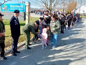 Several young people took part in a tradition to shake hands with veterans following a Remembrance Day ceremony held on Walpole Island First Nation on Nov. 10. Ellwood Shreve/Postmedia