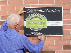 Jim Hathaway, president of the West Lorne and Community Horticultural Society, supports the plaque that is now attached to the West Lorne Community Complex. It highlights the society's 100th anniversary, marked in 2020, although the celebration was delayed because of the pandemic. Supplied