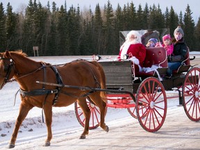 Clare Kirkeby and her daughters, l-r, Bryn, Bailey and Brooke went for a wagon ride with Santa in 2020. Donald Myers has held Santa's Test Run for 10 years.